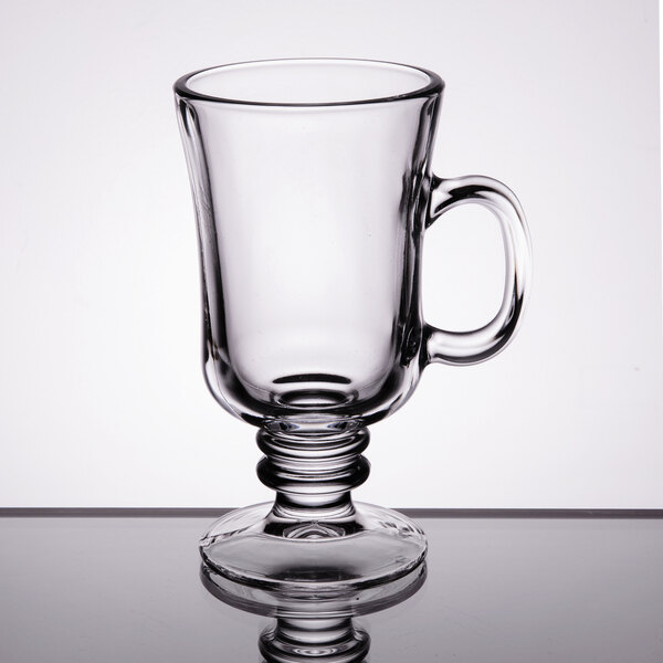 A Libbey clear glass coffee mug with a handle.