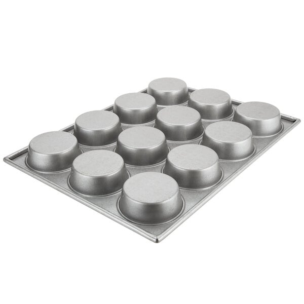 A silver Chicago Metallic mini cake and jumbo muffin pan with 12 cups.