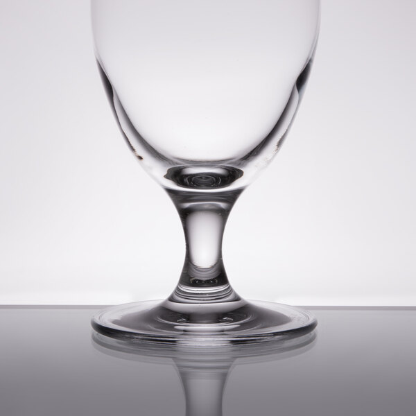 A Stolzle Nadine wine goblet on a reflective surface.