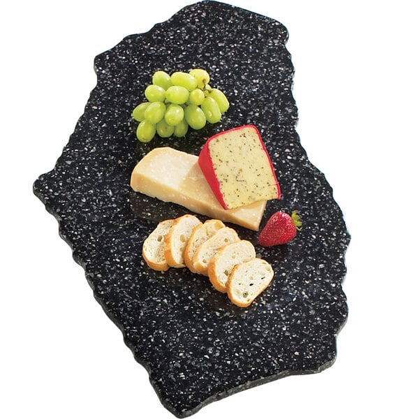 A black simulated stone tray with cheese, grapes, and bread.