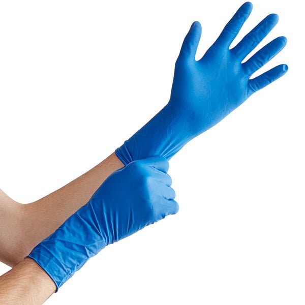A person wearing blue High Risk Latex Exam gloves.
