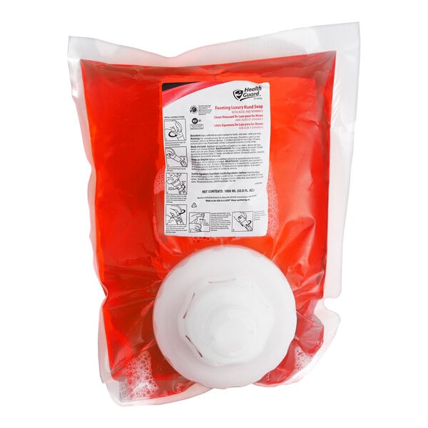 A clear plastic bag filled with red liquid soap, featuring a white dispensing cap and a label with instructions.