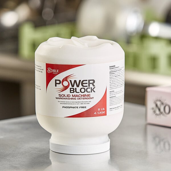 A white container with a red label for Noble Chemical Power Block solid dish machine detergent.