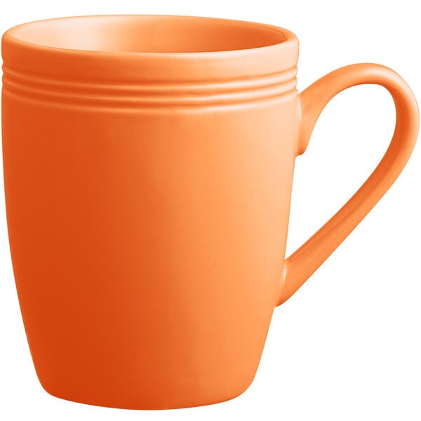 an orange mug with a handle
