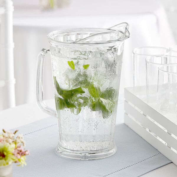 A Cambro clear plastic pitcher filled with water and mint leaves.