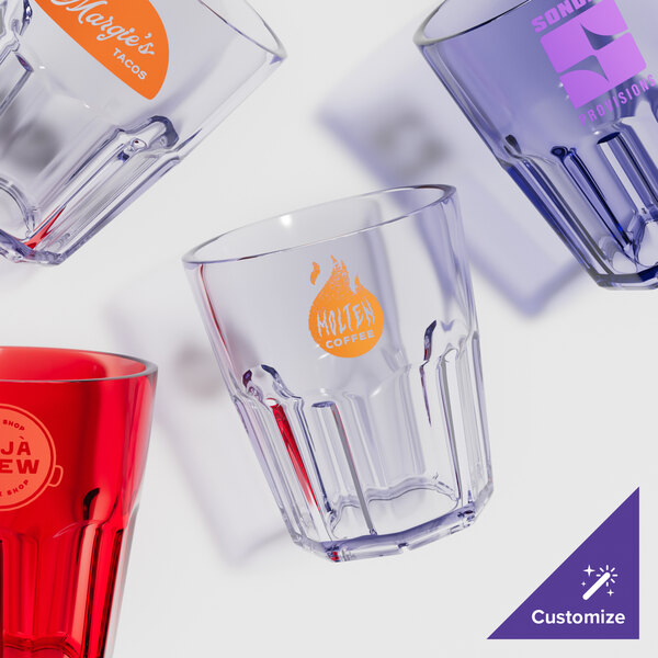 A close-up of a clear plastic tumbler with a red logo.