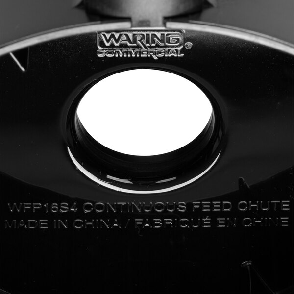 A black plastic cover with the words "Waring" on it over a white circle.