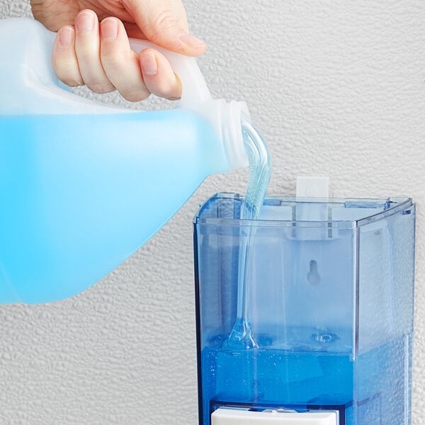 A hand pouring blue Dial liquid hand soap into a plastic container.