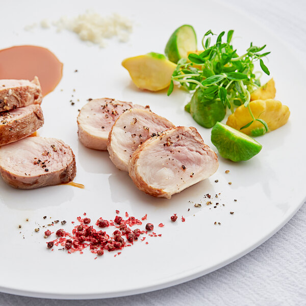 A plate with a close-up of a piece of Big Pop's Whole Alligator meat with spices on it.