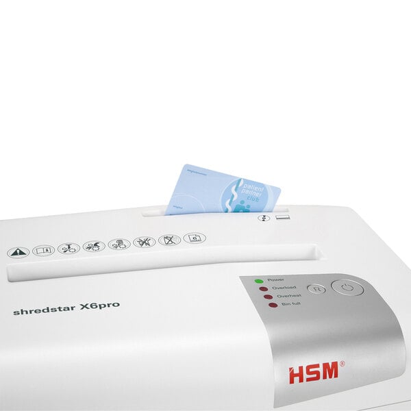 An HSM ShredStar X6pro paper shredder shredding a card.