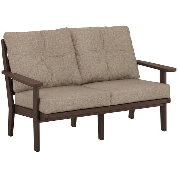 A POLYWOOD mahogany outdoor loveseat with a tan cushion.