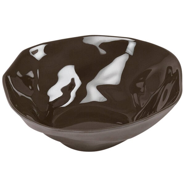 A black Cal-Mil melamine bowl with a white rim.
