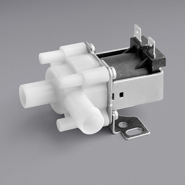 A white plastic Estella Caffe outlet solenoid valve.