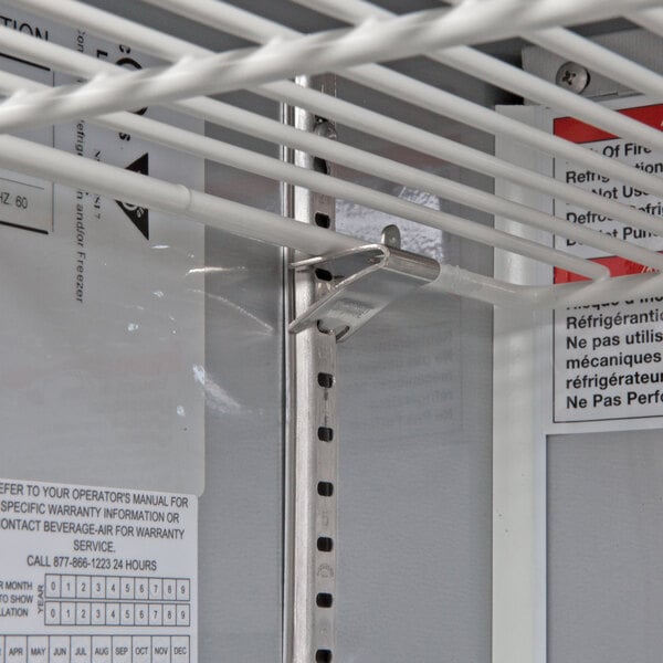 A metal shelf with white metal rods inside a Beverage-Air undercounter refrigerator.