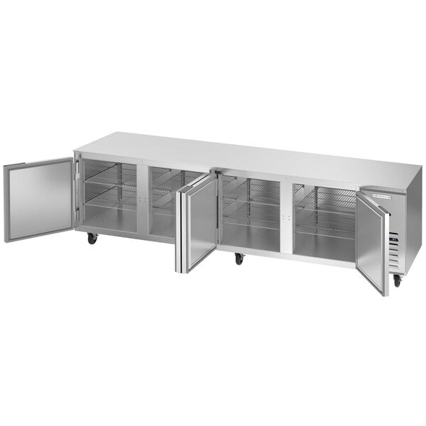A large stainless steel Beverage-Air undercounter refrigerator with three doors open.
