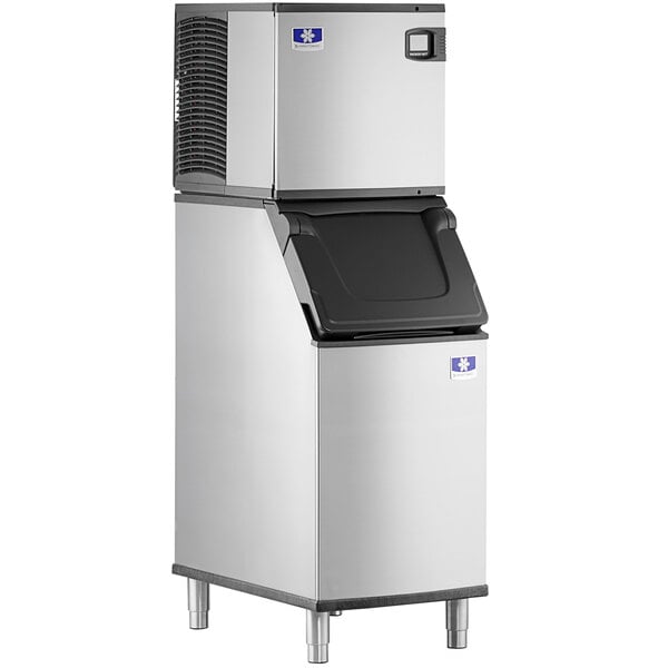 A stainless steel Manitowoc air cooled ice machine with a black top.