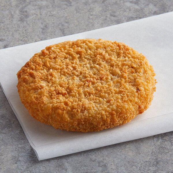 A Mrs. Friday's Original Breaded Krabbycake on a white surface.