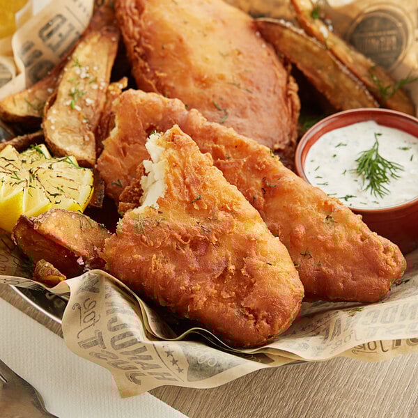 A plate of Mrs. Friday's Craft Beer Battered Cod with fries and dipping sauce.