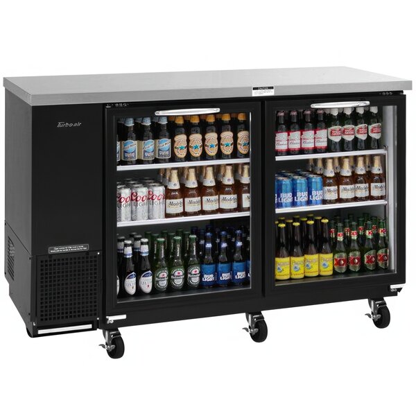 A Turbo Air back bar cooler with glass doors filled with bottles of beer.