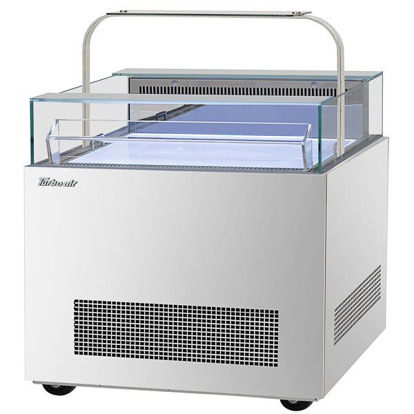 A white rectangular Turbo Air sandwich and cheese display case with a glass top.