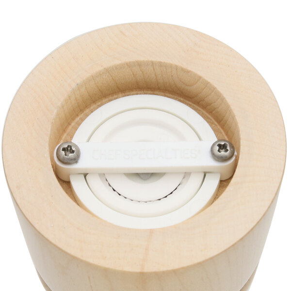 A close-up of a wooden Windsor salt and pepper mill set with white buttons.