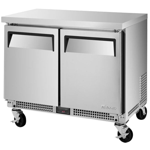 a silver refrigerator with wheels