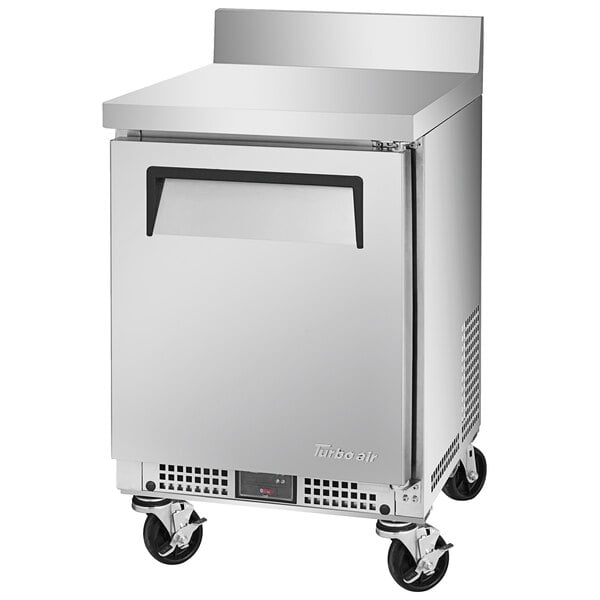 A silver Turbo Air undercounter refrigerator with a black handle and wheels.