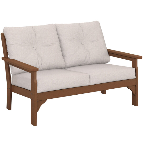 a white couch with brown armrests