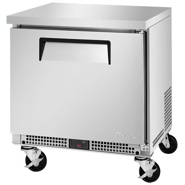 A silver Turbo Air undercounter refrigerator with wheels.