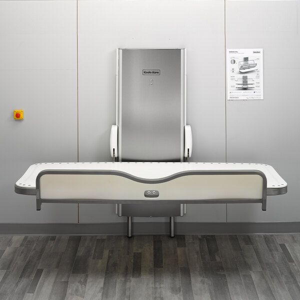 A Koala Kare adjustable height changing station over a hospital bed.