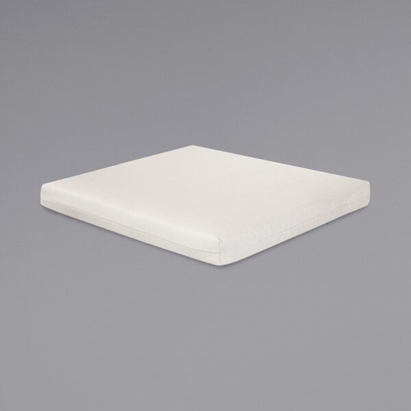 A natural linen POLYWOOD square seat cushion on a gray surface.