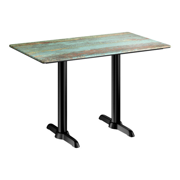 A rectangular standard height table with a textured canyon painted faux metal finish top and two black end base plates.