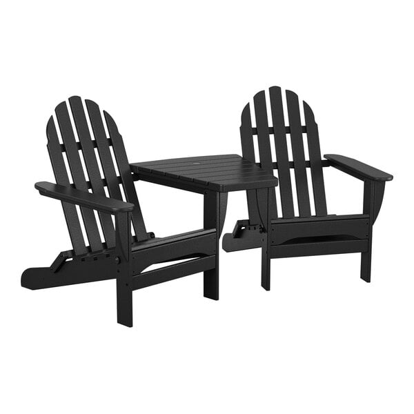 Two black POLYWOOD Adirondack chairs with a connecting table on an outdoor patio.