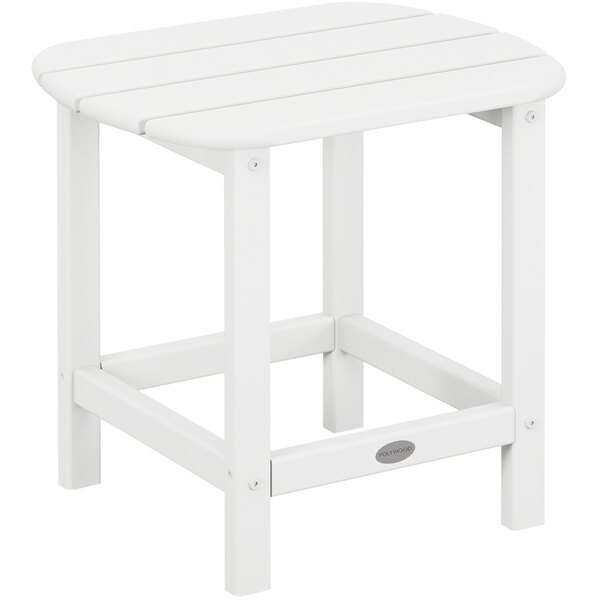 A POLYWOOD white side table with a wooden top on an outdoor patio.