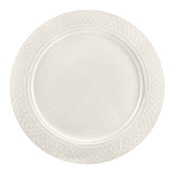 A round, ivory-colored plate with a textured, lattice-like pattern around the rim.