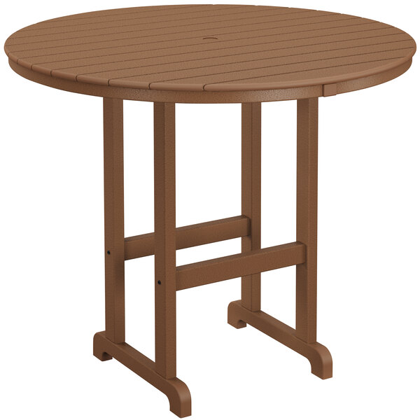 A brown POLYWOOD round bar height table on an outdoor patio.