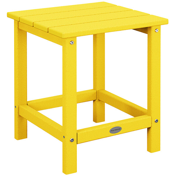 A POLYWOOD lemon yellow side table on a wooden outdoor patio.