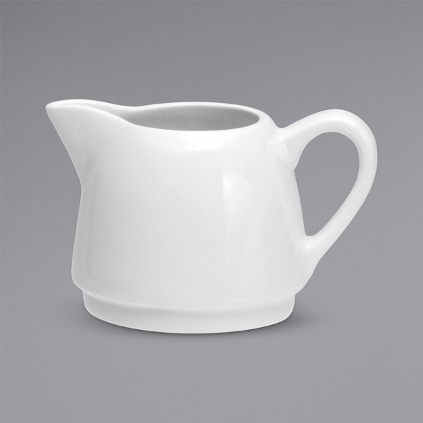 A Oneida Tundra warm white china creamer with a handle.