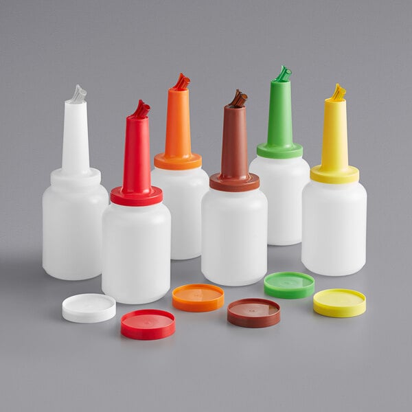 A group of Choice plastic pour bottles with assorted colored caps.