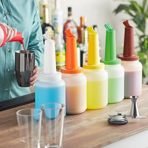 A man pouring liquid into a blue Choice pour bottle with a blue cap.