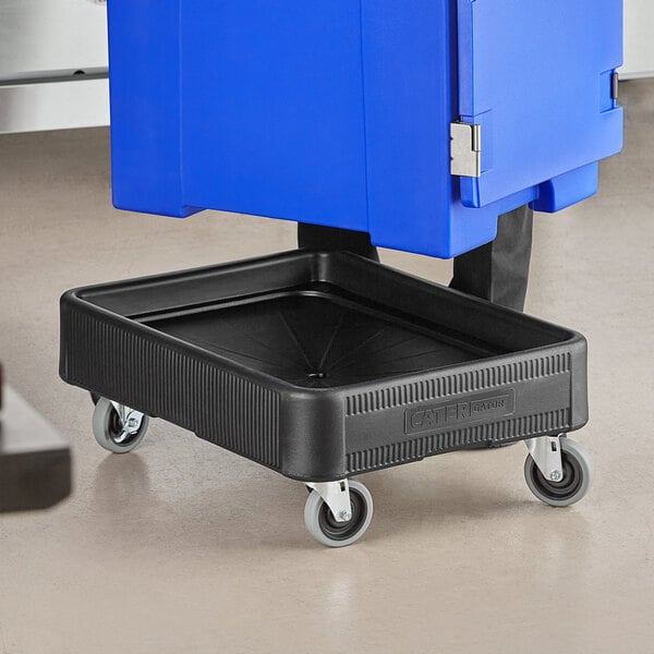 A person using a black CaterGator dolly to move a blue insulated food pan carrier.