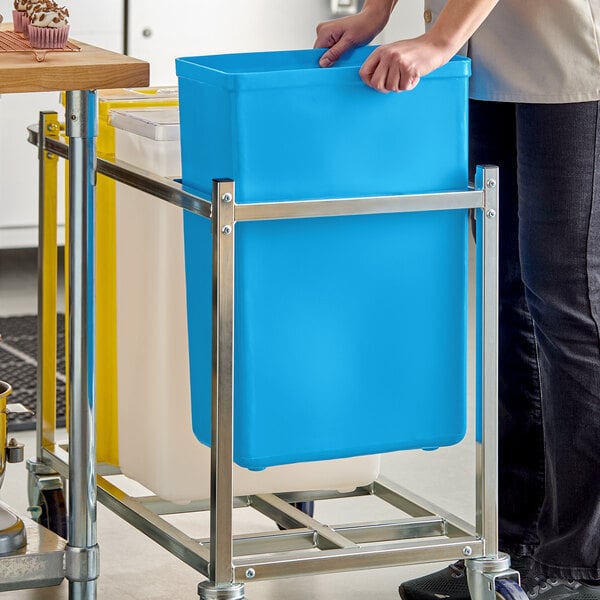 A blue 10-gallon ingredient bin on a metal cart.