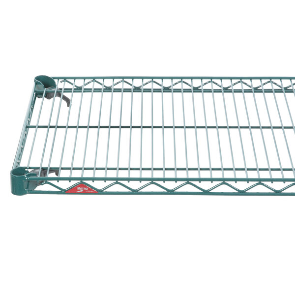 A Metroseal green wire shelf on a metal frame.