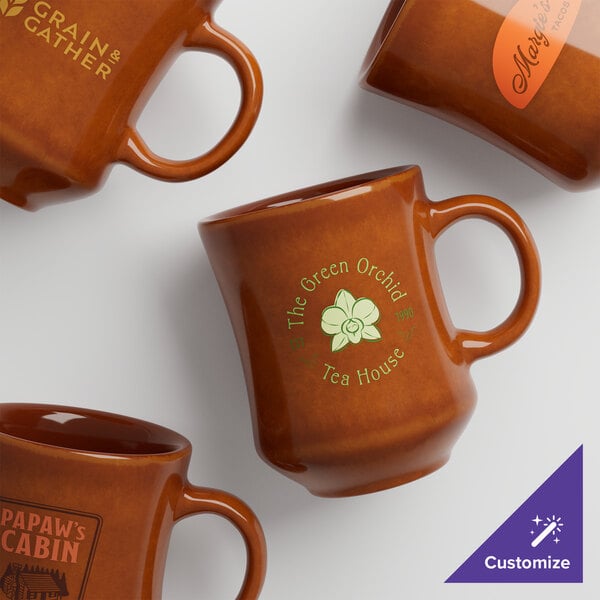 A close up of a brown Acopa stoneware coffee mug with a logo on it.