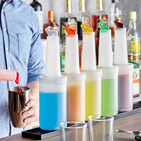 A man pouring colorful liquid from a Choice pour bottle into a cup.