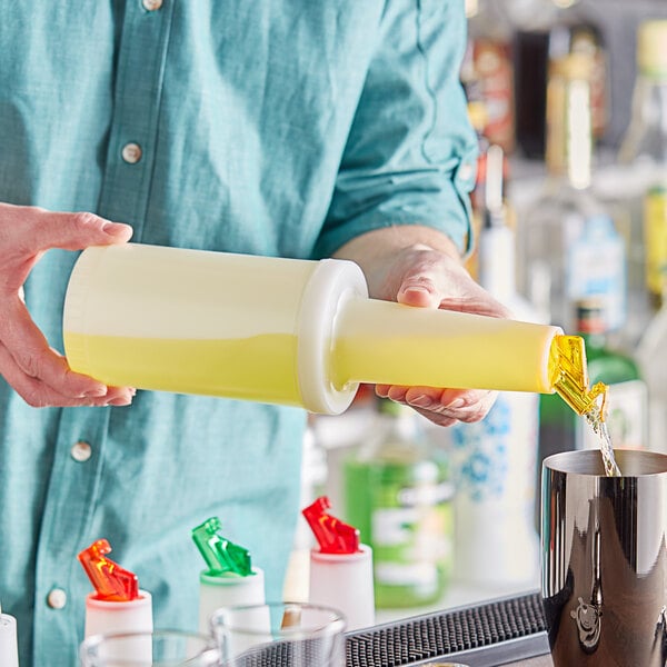 A person pouring yellow liquid from a Choice plastic container with a yellow flip top into a cup.