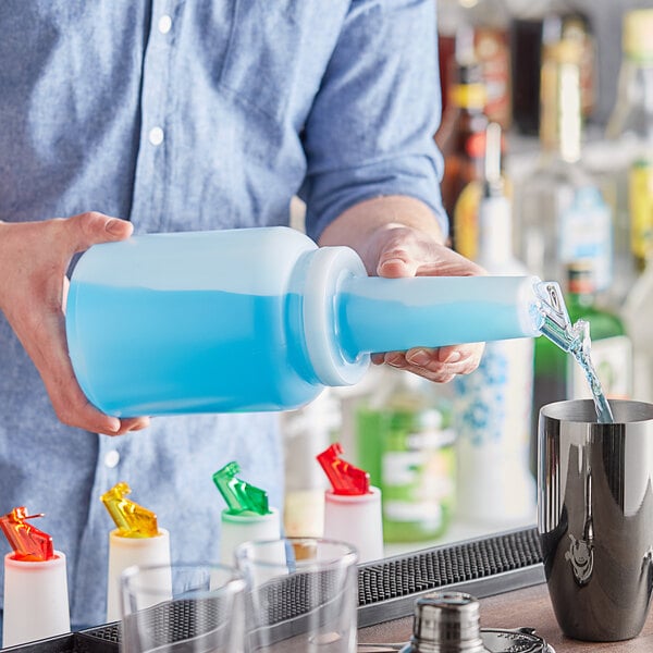 A person pouring blue liquid from a Choice glass container with a white flip top and cap.