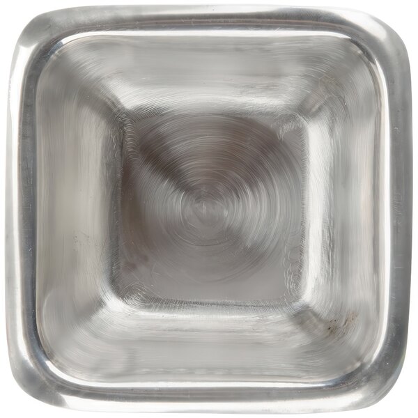 An American Metalcraft stainless steel square sauce cup with a shiny metal surface.