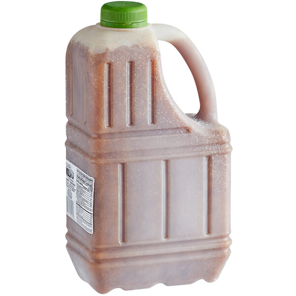 A plastic jug of Elixir Tamarind Pulp with a green cap.