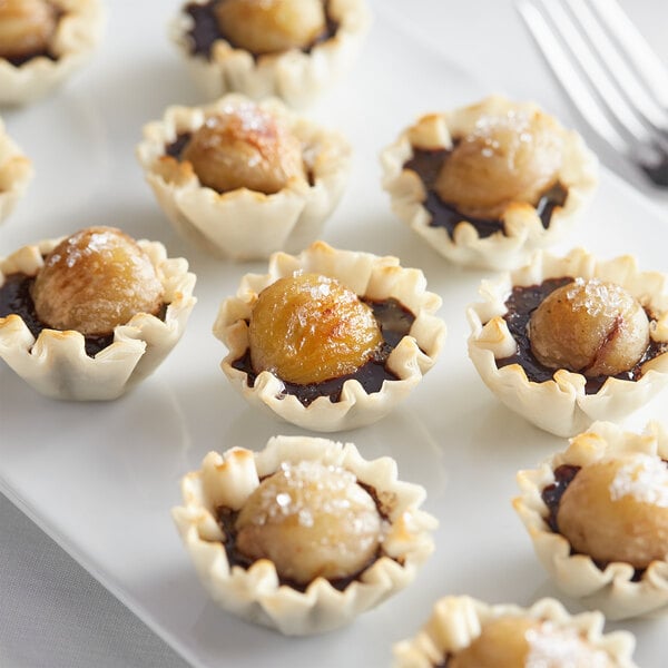 A white plate topped with White Toque peeled chestnuts.